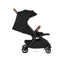 Compact black stroller with brown handle, featuring a reclining seat and adjustable canopy, ideal for travel.