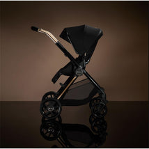 Silver Cross Reef 2 modular stroller in Espresso Special Edition, featuring a sleek black design with gold accents and a reclining seat.