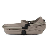 Silver Cross Reef First Bed Folding Bassinet in Frappe color, featuring a sleek, compact design for easy transport.