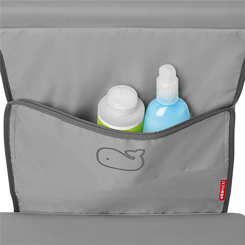 Grey Skip Hop Baby Bath Moby elbow saver and kneeler with visible storage pocket holding a green bottle and a blue spray bottle.