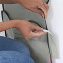 Hands adjusting the grey Skip Hop Moby Baby Bath Elbow Saver & Kneeler, showcasing its practical design and functionality.