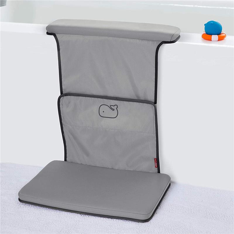 Grey Skip Hop Baby Bath Moby All-In-One Elbow Saver & Kneeler with a whale logo, placed next to a bathtub.