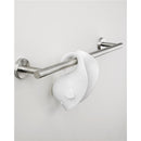 White Skip Hop Baby Bath Spout Cover with a playful design, hanging on a metal towel bar against a neutral wall.