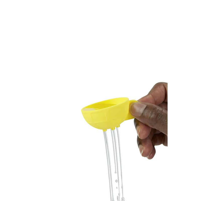 Hand holding a yellow boat-shaped bath toy with water pouring out, part of the Skip Hop Baby Bath Toy Croc set.