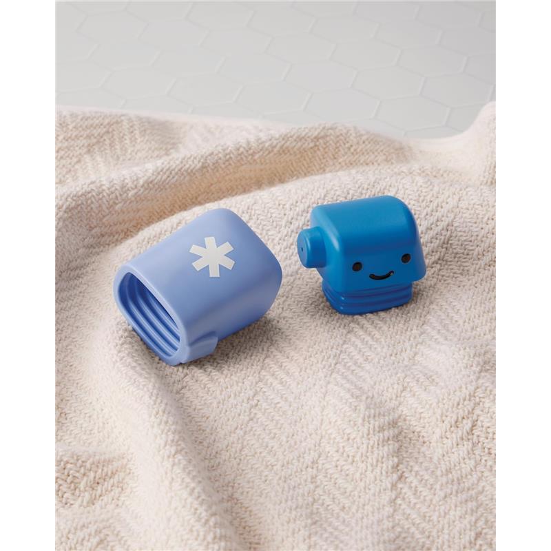 Two blue baby bath toys on a textured blanket, including a smiling robot and a cup with a white snowflake design.
