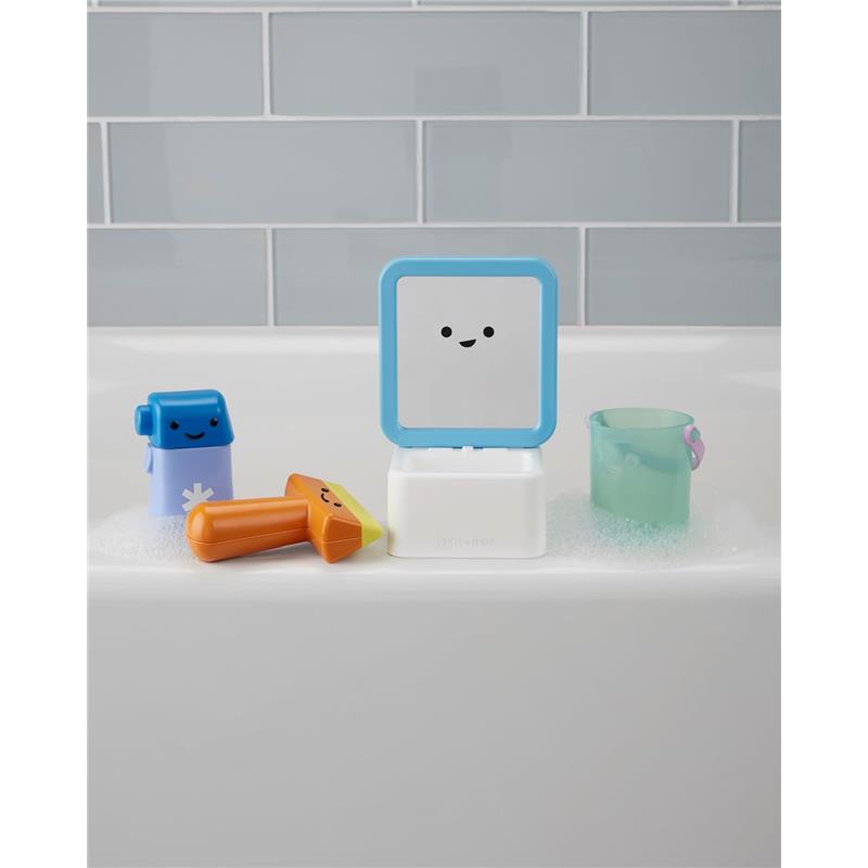 Baby bath toy set featuring a smiling mirror, colorful bath toys, and a small transparent cup in a bubble-filled tub.