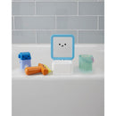 Baby bath toy set featuring a smiling mirror, colorful bath toys, and a small transparent cup in a bubble-filled tub.