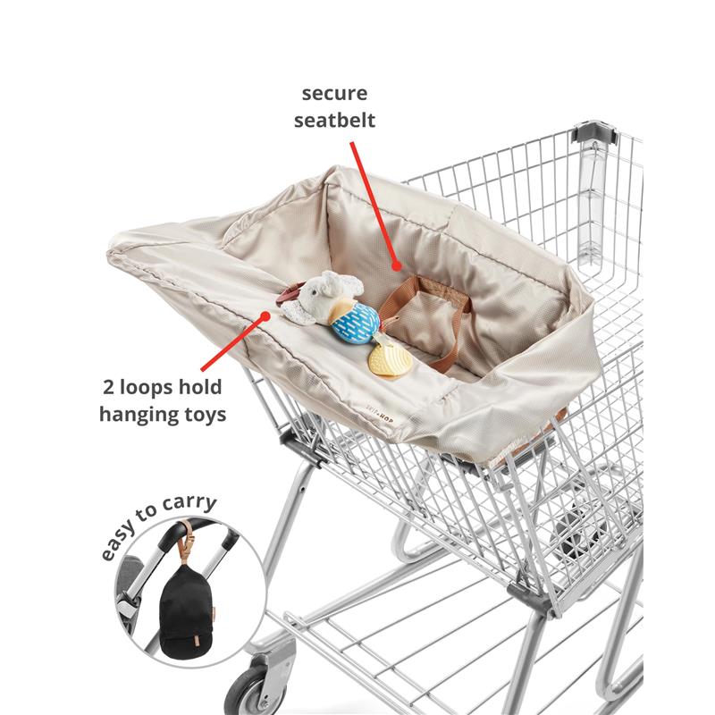 Skip Hop Baby Shopping Cart Cover in oat color with secure seatbelt, loops for toys, and easy carry design, fitted in a shopping cart.