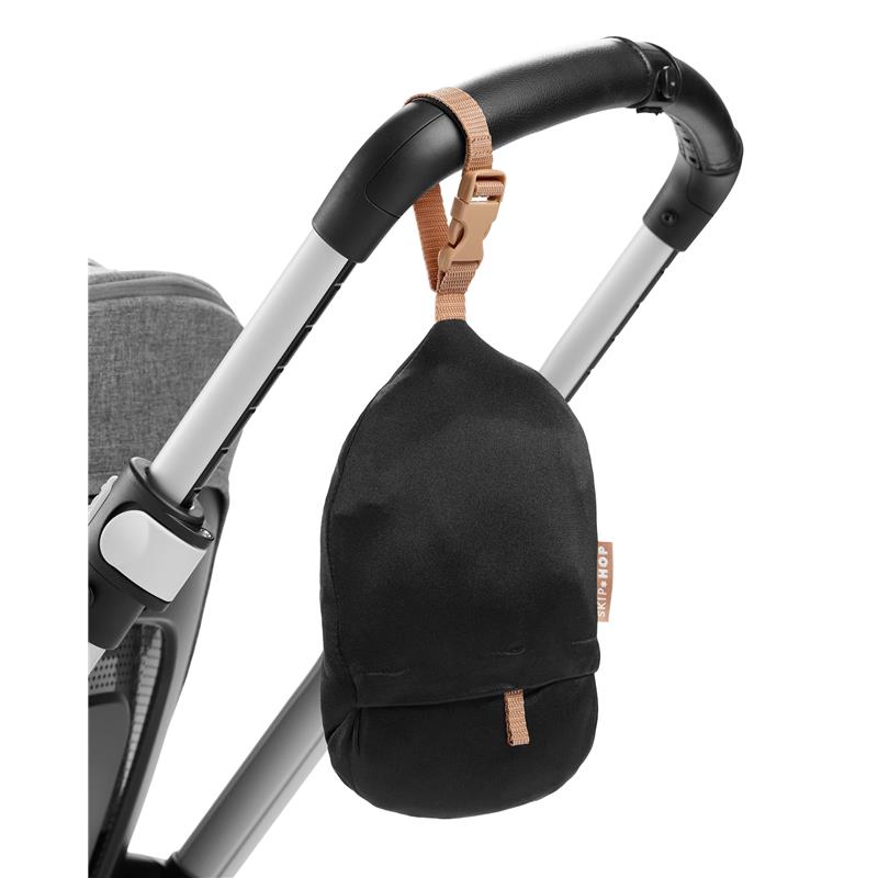 Black storage pouch with a tan strap, attached to a stroller handle, designed for the Skip Hop Baby Shopping Cart Cover.