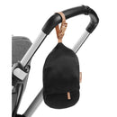 Black storage pouch with a tan strap, attached to a stroller handle, designed for the Skip Hop Baby Shopping Cart Cover.