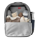 Navy Skip Hop Flex Sporty Diaper Bag Backpack with organized compartments, including clothing, a bottle, and baby essentials.