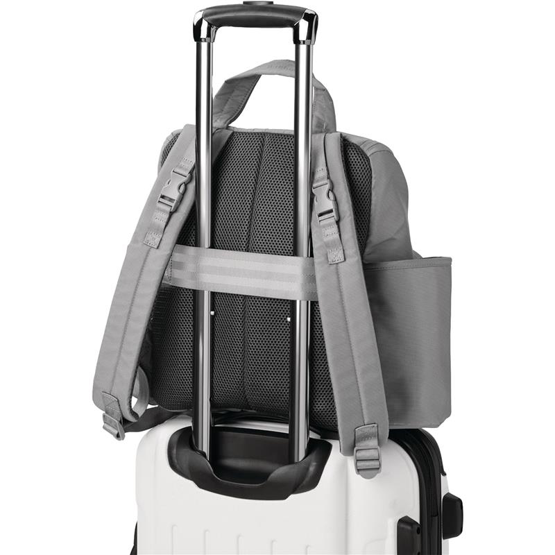 Grey Skip Hop diaper bag backpack is attached to a wheeled suitcase for easy transport.