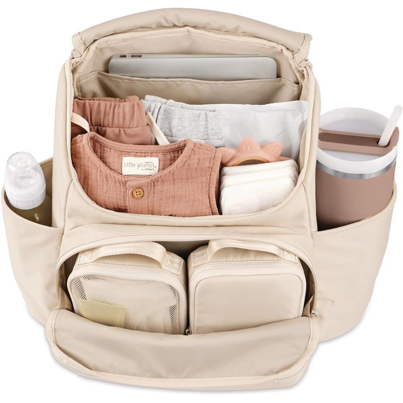 Skip Hop diaper bag backpack in Oat color, featuring various baby essentials like clothes, a changing pad, and a water bottle.