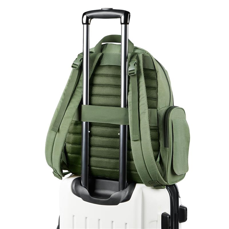 Sage Skip Hop Diaper Bag Backpack mounted on a wheeled luggage handle, featuring padded straps and side pocket.