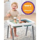 Toddler playing with Skip Hop Discoverosity 3-in-1 Sensory Table, featuring colorful activities, while a finalist badge is visible.