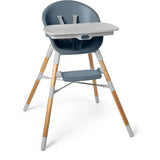 Slate blue Skip Hop EON 4-in-1 high chair with a wooden frame, removable tray, and safety straps for children.
