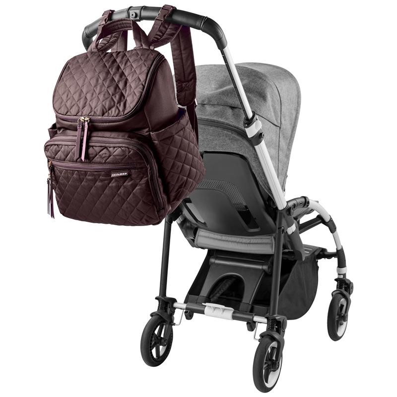 Forma Backpack in Chocolate color attached to a stroller, featuring a quilted design and multiple zippered pockets.