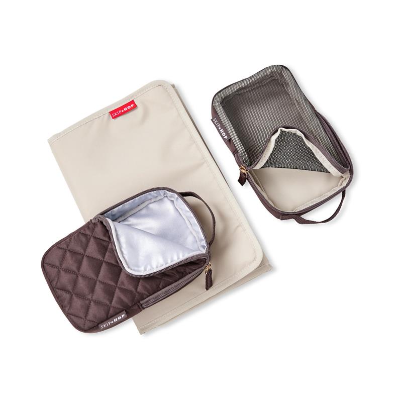 Skip Hop Forma Backpack in chocolate features a quilted brown packing cube and a mesh zippered pouch on a beige background.