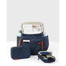 Navy Skip Hop Forma Diaper Bag Backpack, featuring multiple compartments and included accessory pouches, open with contents visible.