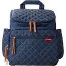 Navy quilted diaper bag backpack by Skip Hop featuring dual zippers, tan leather accents, and multiple pockets.