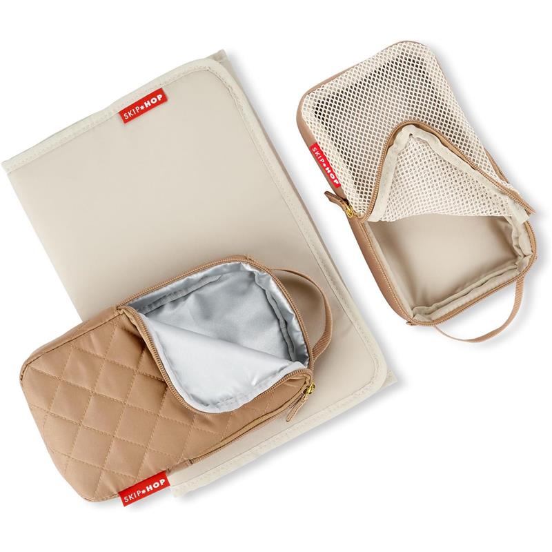 Skip Hop Forma Diaper Backpack features a quilted camel-colored pouch and a beige organizational mat with a mesh pocket.