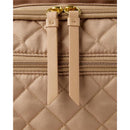 Quilted tan fabric of the Skip Hop Forma Diaper Backpack with gold hardware and zippered compartments.