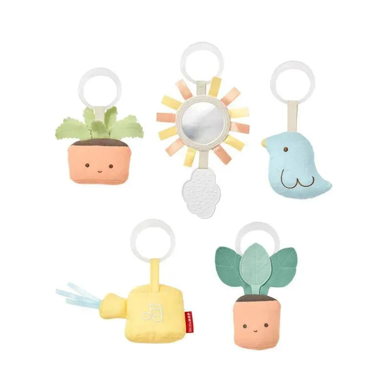 Colorful soft toys including a mirror, bird, watering can, and potted plants, designed for the Skip Hop Garden Oasis Activity Gym.