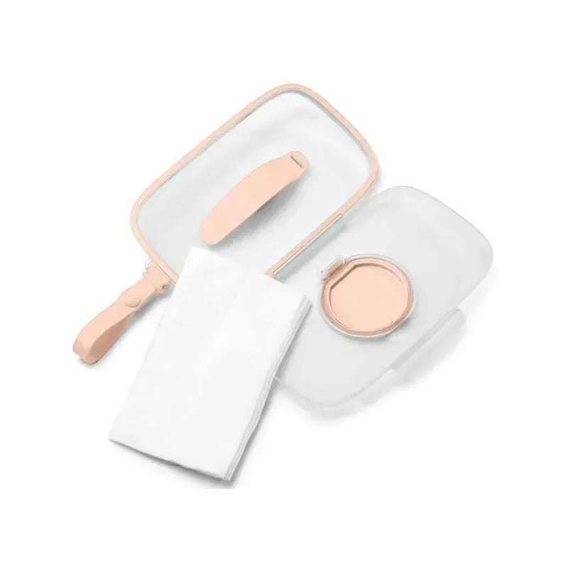 Blush-colored Skip Hop Grab & Go Snug Seal Wipes Case with a white cloth and snap closure lid.