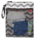 Wet/dry bag by Skip Hop features a chevron pattern with visible blue diaper, wipes, and cream inside the mesh pouch.