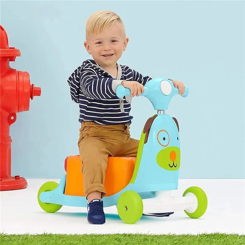 Toddler riding a blue and orange Skip Hop 3-in-1 ride-on toy designed as a dog, with a red fire hydrant in the background.