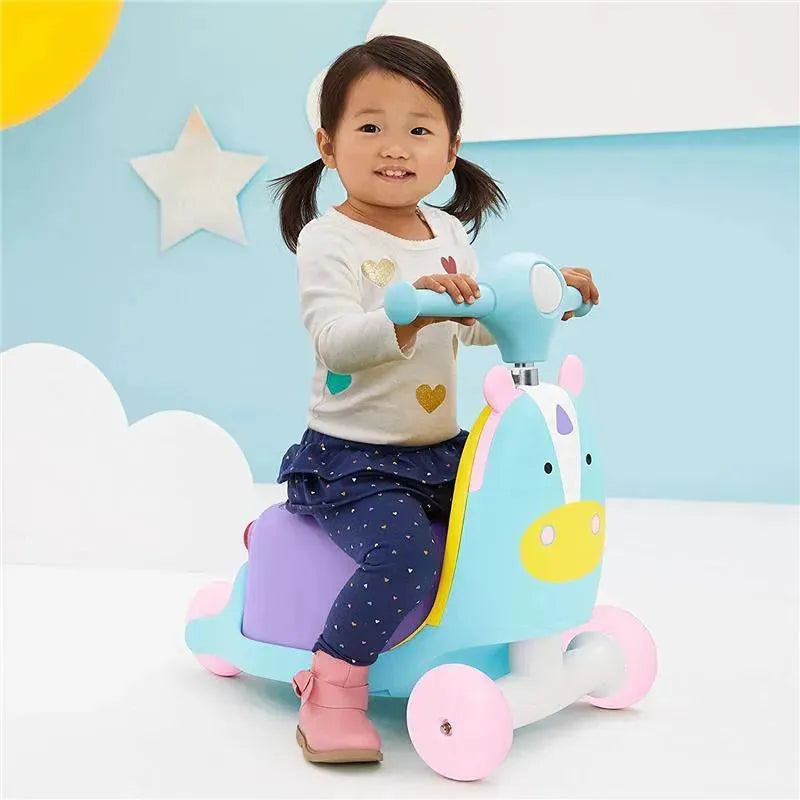 Child riding a colorful unicorn-themed ride-on toy, smiling and holding the handlebars, against a playful background.