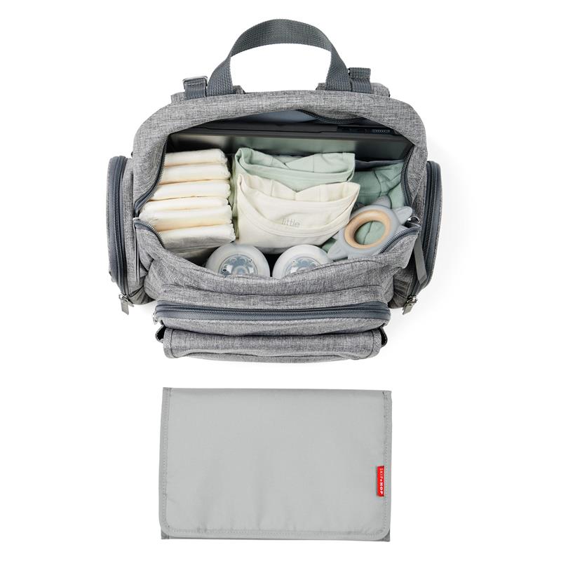 Heather grey Skip Hop Luna diaper bag backpack, open to reveal diapers, wipes, bottles, and a portable changing pad below.
