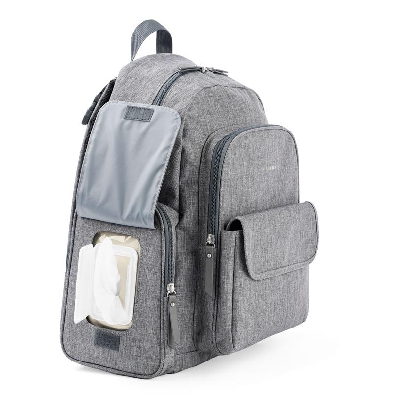 Heather grey Skip Hop Luna diaper bag backpack featuring a front pocket with a portable changing pad and wipes container.