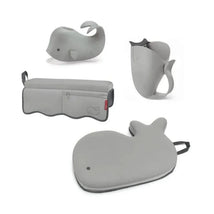 Grey Moby Baby Bath Essential Set from Skip Hop featuring a whale-shaped bath toy, pitcher, and a bath mat.