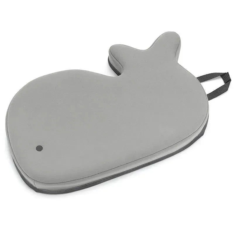 Grey whale-shaped bath mat from the Skip Hop Moby Baby Bath Essential Set, featuring a handle for easy transport.