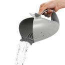 Grey whale-shaped bath pouring cup pouring water, designed for babies in the Skip Hop Moby Bath Essential Set.