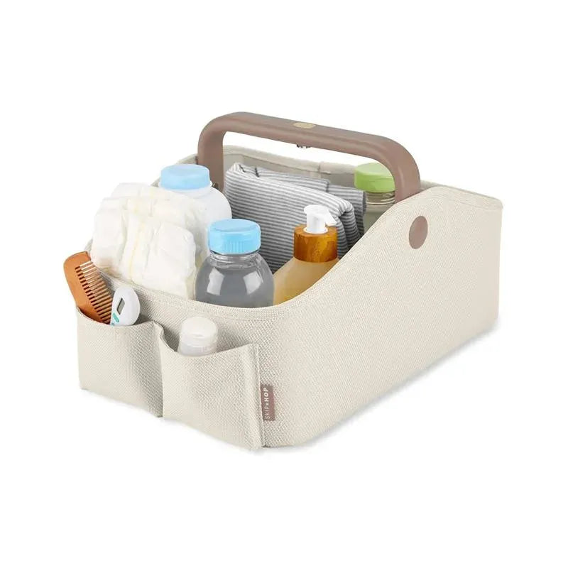 Nursery Style Light Up Diaper Caddy by Skip Hop in oat color, filled with bottles, diapers, and baby care products.