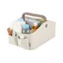 Nursery Style Light Up Diaper Caddy by Skip Hop in oat color, filled with bottles, diapers, and baby care products.