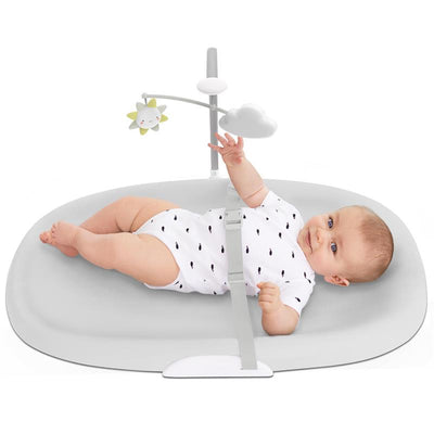 Wipe-clean changing pad in grey featuring a baby in a white onesie reaching for a hanging toy with a sun and cloud.
