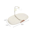 Skip Hop Nursery Style Wipe-Clean Changing Pad in oat color, featuring a safety strap and a detachable toy bar with sun and cloud.