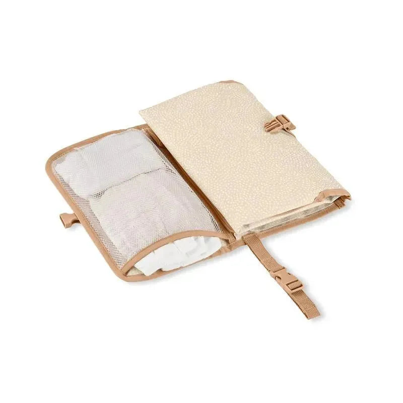 Portable baby changing pad in beige swirl dot design, featuring a mesh compartment for storage and secure fastening strap.