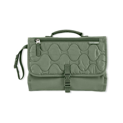 Portable baby changing pad in sage color with quilted texture, foldable design, and a secure buckle closure.
