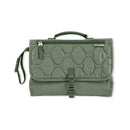 Portable baby changing pad in sage color with quilted texture, foldable design, and a secure buckle closure.
