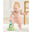 Baby in pink overalls interacts with Skip Hop Farmstand Push and Spin Toy, featuring colorful characters and a spinning mechanism.