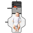 Portable baby changing pad in grey melange with a baby lying on it; features pockets for storage.