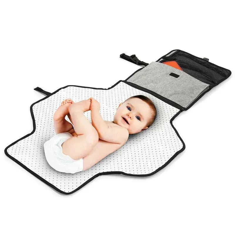 Portable baby changing pad in grey melange with a baby lying on it, featuring a soft dotted surface and storage pocket.