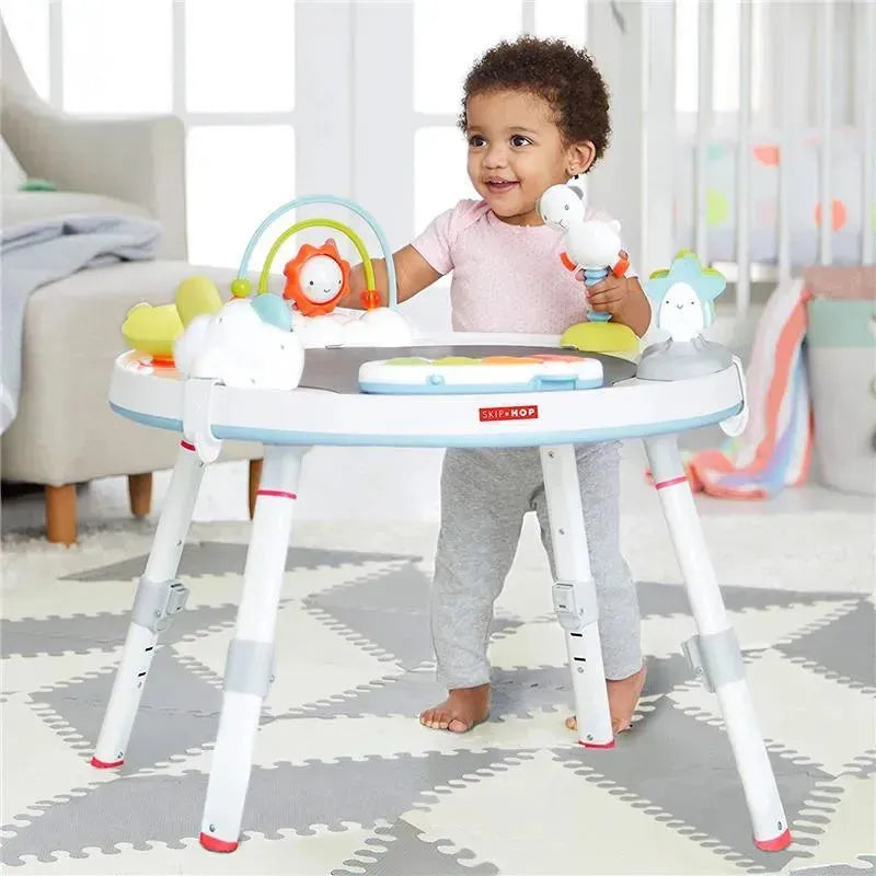 Toddler playing with the Skip Hop Silver Lining Cloud Activity Center, featuring colorful toys and an engaging design.