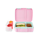 Bento box in pink with sandwich, pretzels, and two containers of fruit, featuring a lid and compartments.