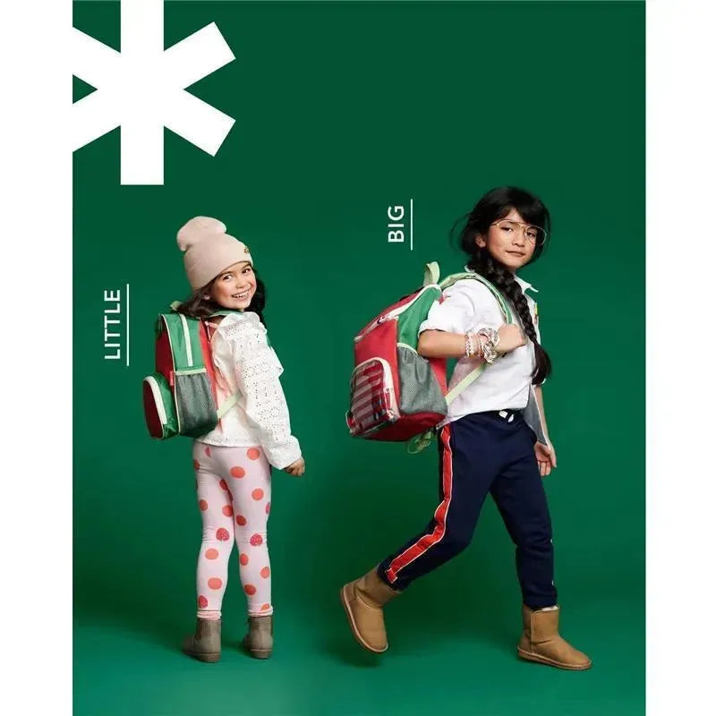 Two kids showcasing the Skip Hop Spark Style Big Kid Backpack, one wearing a smaller version in red and the other a larger one in green.