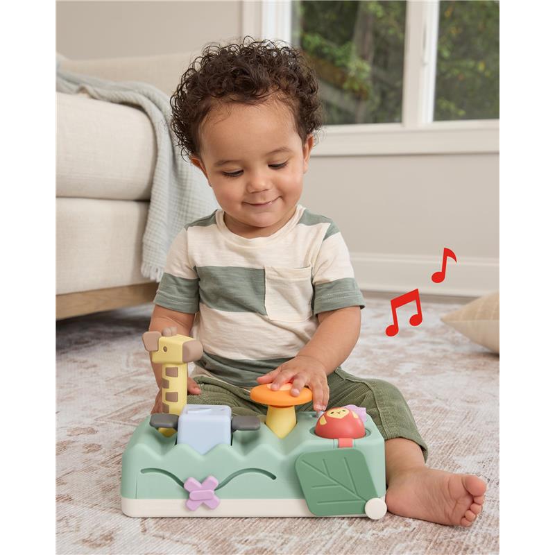 Baby playing with the Skip Hop Tummy Time musical toy featuring animal sounds, lights, and interactive buttons.